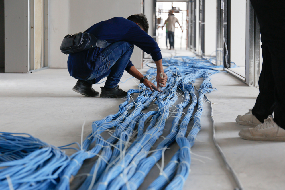 Worker pulling CAT6 Cables